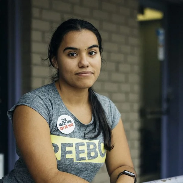 Photograph of Forest Park native Joana Ibarra outside of her smoothie shop, featured in the State of Flux Story Map